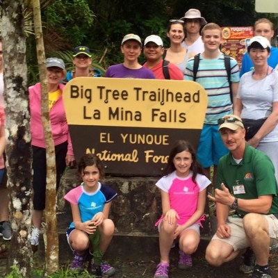 tourists in front of El yunque sign